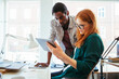 © Geber86 - Young group of designers using a tablet in a modern business office