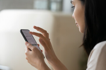 Close up Asian woman using phone, surfing internet, chatting online, looking at smartphone screen, typing writing message in social network, young female holding cellphone, scrolling, browsing apps