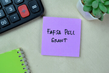 Wall Mural - Concept of Fafsa Pell Grant write on sticky notes isolated on Wooden Table.