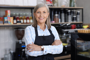 Wall Mural - Portrait of happy business owner in her coffee shop