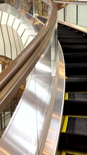 Going Up On A Modern Escalator. Upward Motion As An Escalator Moves From One Floor To The Next. Modern Architecture With Glass Panels.