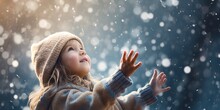 An Exuberant Toddler With Arms Reaching To The Sky, As The First Snowflakes Of Winter Land Gently On Outstretched Palms, With Snow-covered Trees In The Background, Copy Space