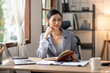 © David - Young business asian woman working at home with laptop and papers on desk