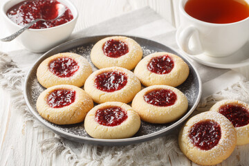 Poster - Hallongrottor or Swedish rapsberry caves jam cookies closeup on the plate on the white wooden table. Horizontal