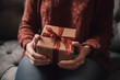 Woman holding christmas gift at home