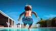 Back view of kid jumping on resort pool 