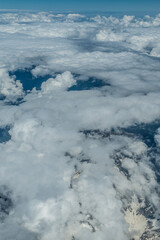 Wall Mural - White heavy clouds in the blue sky. Panoramic cloudscape above the clouds.