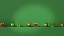 Christmas Tree Balls And Gift Boxes Roll Pushing Each Other On A Green Background. Christmas And New Year Concept. 3D Render. Seamlessly Looped Video.