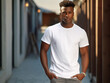 A mockup of an young black man wearing a white T-shirt, outdoor background
