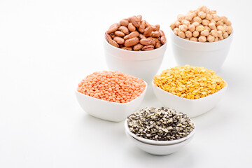 Canvas Print - Variety of legumes and lentils in bowl on white background