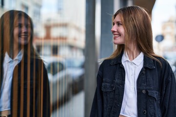 Poster - Young blonde woman smiling confident looking to the side at street