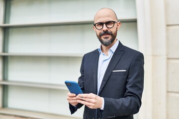 Sticker - Young bald man business worker smiling confident using smartphone at street