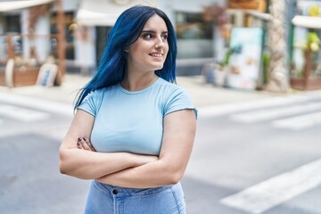 Poster - Young caucasian woman standing with arms crossed gesture at street