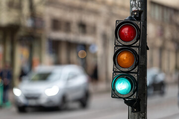 Wall Mural - traffic light on the street junction with beautiful bokeh, city with cars in the background