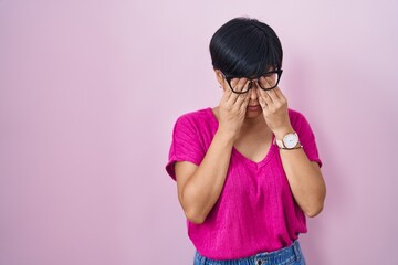 Poster - Young asian woman with short hair standing over pink background rubbing eyes for fatigue and headache, sleepy and tired expression. vision problem