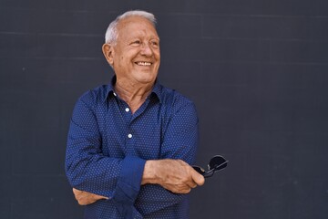 Poster - Senior grey-haired man smiling confident standing with arms crossed gesture over black background