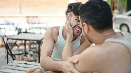 Sticker - Two men couple sitting on table speaking at coffee shop terrace