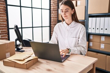 Wall Mural - Young caucasian woman ecommerce business worker using laptop working at office