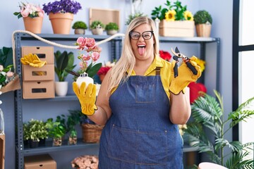 Poster - Caucasian plus size woman working at florist shop sticking tongue out happy with funny expression.