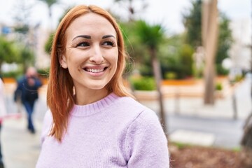 Wall Mural - Young caucasian woman smiling confident looking to the side at park