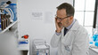© Krakenimages.com - Serious hispanic scientist at lab, suffering headache while working, a mid-life crisis?