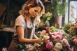 A woman florist collects a beautiful bouquet of flowers in a flower shop