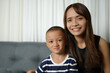 © buraratn - Mother and son smiling happily inside the house