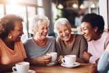 Fototapeta  - Happy smiling middle aged female friends sitting in a café laughing and giving support each other. They are celebrate a long friendship