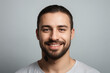 © Delta Amphule - Everyday people. A smiling man with a short beard. Wearing a t-shirt. On a light background. Friendly man. Down-to-earth and approachable. Portrait.