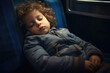 © Konstiantyn Zapylaie - Exhausted young boy napping on a train seat during a lengthy journey
