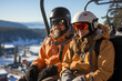 A couple on a chairlift on the mountains in winter. Ski lift, ski resort, ski slope. Snowboarders going up a mountain.