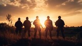 Fototapeta Tulipany - A group of mercenary soldiers during patrol and security of the territory. They move across the steppe terrain in the rays of the setting sun.