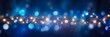 Festive Holiday Background: Blue Bokeh Lights and Glowing Christmas Garland Decoration