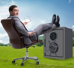 Wall Mural - Businessman resting putting leg on safe