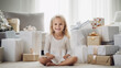 5 years old girl sitting on the floor with Christmas gifts in white living room, Christmas morning, blonde little girl, minimalist hygge interior, Scandi room, smiling child looking at camera