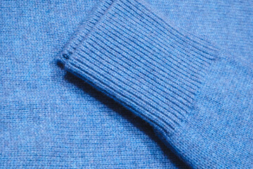 Poster - blue sweater lies on a shelf in a luxury store close-up