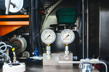 Poster - air conditioner technician using manifold gauge checking refrigerant for filling home air conditioning and air duct cleaning and maintenance outdoor compressor unit.