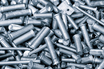 Texture background of metal products screws, nozzles, bolts and studs for welding equipment, industrial concept background