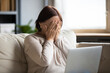 © fizkes - Elderly woman sit on couch hold pc on lap cover face with hands during thriller movie scary moment, cant believe in luck online lottery win crying from happiness, received awful bad news feels unhappy