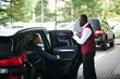 © AnnaStills - Doorman meeting the guest outside while she getting out of the car