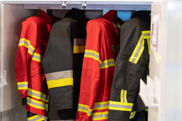 Hanging firefighter jackets and helmets.