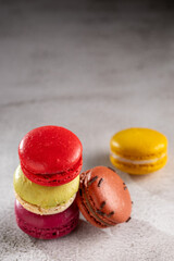 Sticker - Delicious macaroons on the table. Macarons cakes in different colors.