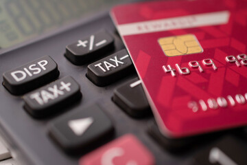 Closeup of credit card with calculator