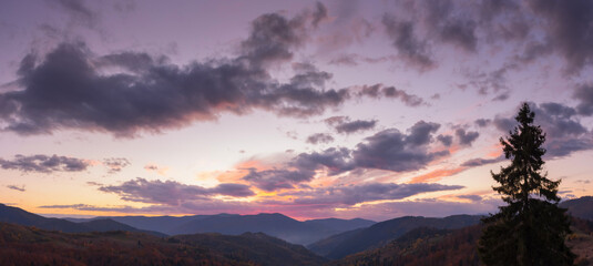 Wall Mural - dramatic cloudscape above the mountains at dusk. sky in colorful evening light. changing weather for