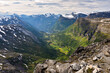 Mountains landscape at sunset, Geirangerfjord and winding road Nibbevegen from Dalsnibba viewpoint, Norway.
