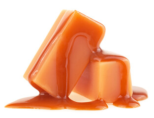 Two caramel candies and milk caramel sauce isolated on a white background