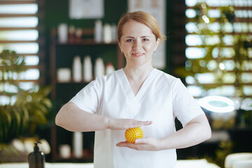 Poster - happy female medical massage therapist in massage cabinet