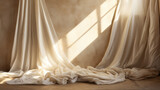 Fototapeta  - Silk curtains hang from above on a beige wall. Light comes in through a window from the side.