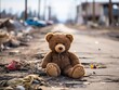 A brown children toy teddy bear sits on the ruins of a building with blurred destroyed building background. can be use for news, illustration, presentation, wallpaper, motivation