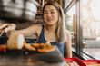 © Sevendeman - Happy asian woman eating korean grilled buffet in the restaurant.